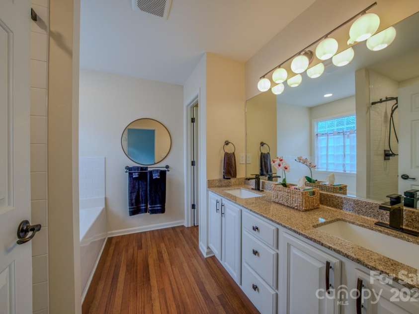 36 Stone River Drive, Asheville, NC 28804.  MLS# CAR4268666, YatesRealty ID 23301. Primary bathroom with double sink vanity.