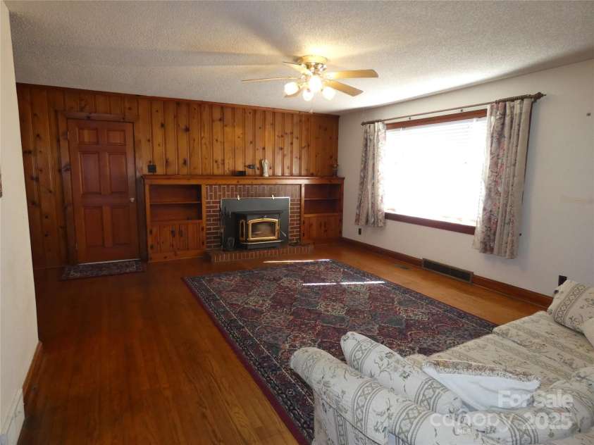 150 Fonda Road, Statesville, NC 28677.  MLS# CAR4321671, YatesRealty ID 2331. Living Room with Woodstove