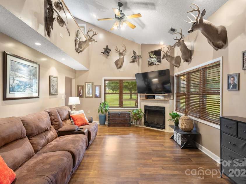 3451 Greene Road, Monroe, NC 28110.  MLS# CAR4271557, YatesRealty ID 23327. Large Living Room with fireplace to snuggle on those cold nights
