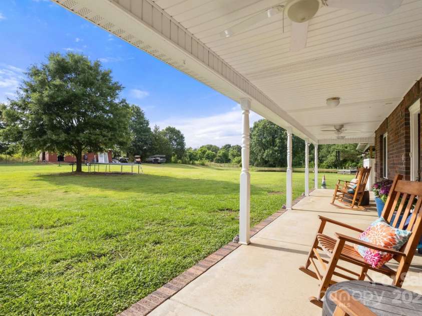 3451 Greene Road, Monroe, NC 28110.  MLS# CAR4271557, YatesRealty ID 23327. Large wrap around  covered Rocking Chair Porch