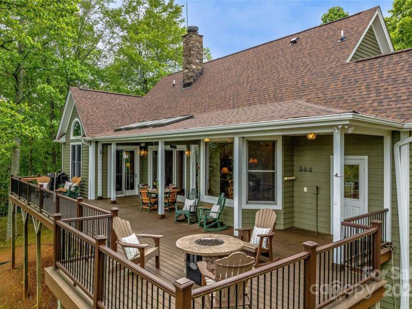 1987 Rabbit Hop Road, Spruce Pine, NC 28777.  MLS# CAR4270357, YatesRealty ID 23328. Back deck off the main house.  It features a covered area with skylights and firepit