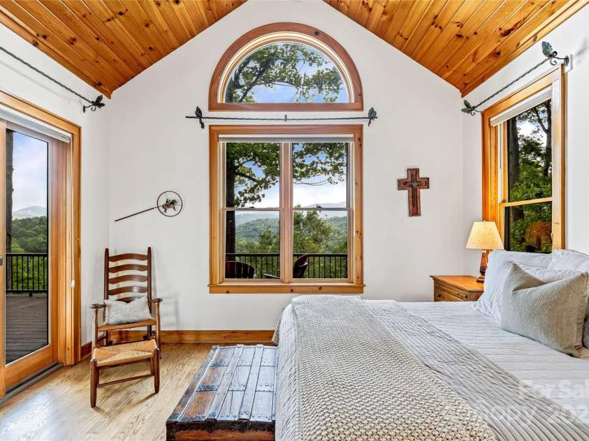 1987 Rabbit Hop Road, Spruce Pine, NC 28777.  MLS# CAR4270357, YatesRealty ID 23328. Primary Bedroom with mountain views and an en-suite bath with soaking tub