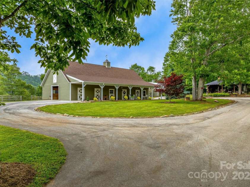 1987 Rabbit Hop Road, Spruce Pine, NC 28777.  MLS# CAR4270357, YatesRealty ID 23328. Stable is a custom Center Aisle Design by“Barns by Gardner” with 6 stalls, wash stall,hay barn, laundry room and studio apartment
