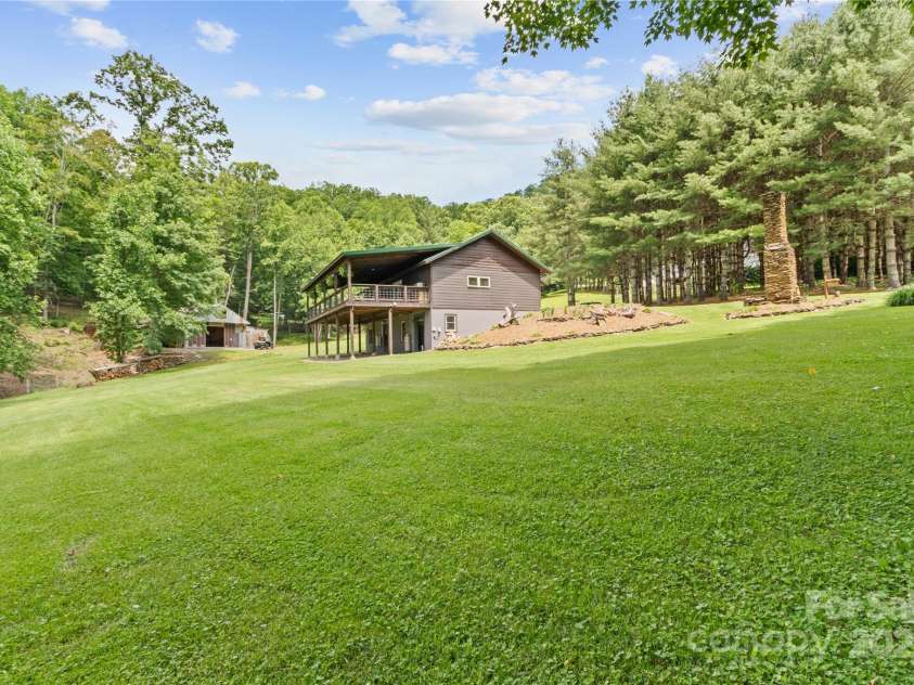 47 Old Chimney Drive, Burnsville, NC 28714.  MLS# CAR4269340, YatesRealty ID 23334. Left side of the house looking toward the workshop