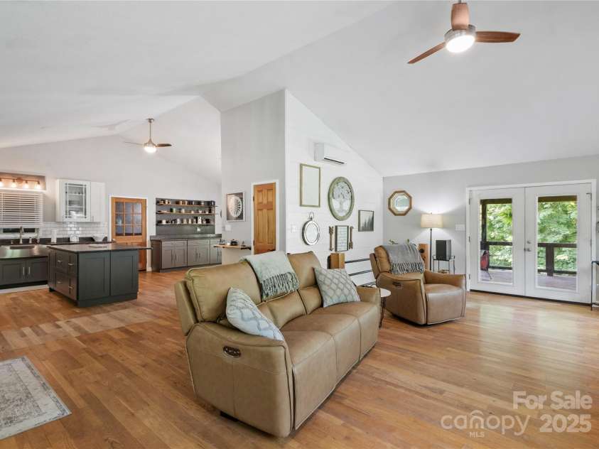 47 Old Chimney Drive, Burnsville, NC 28714.  MLS# CAR4269340, YatesRealty ID 23334. Open living room and kitchen. French doors leading to deck