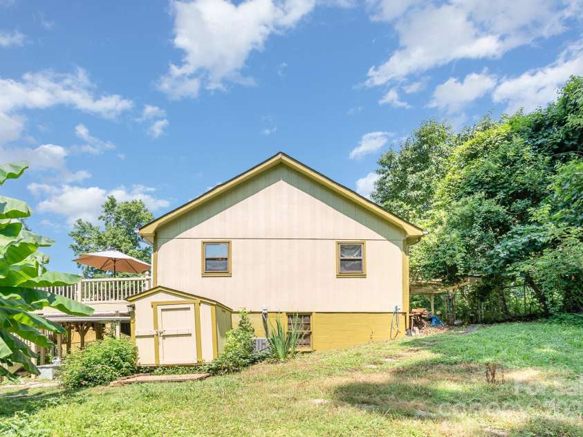 4124 Oakwood Road, Charlotte, NC 28269.  MLS# CAR4276165, YatesRealty ID 23335. Rear view of home. 3 sheds in total all convey. Basement entryway under the deck area.