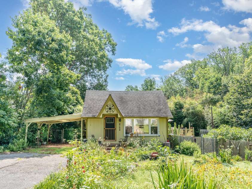 4124 Oakwood Road, Charlotte, NC 28269.  MLS# CAR4276165, YatesRealty ID 23335. Welcome home to this cozy cottage nestled in a serene and inviting landscape