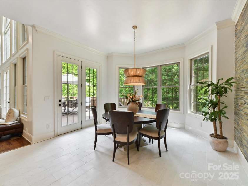 633 Elmhurst Drive, Fort Mill, SC 29715.  MLS# CAR4245784, YatesRealty ID 23352. Enormous  Dining Area featuring marble flooring, stone wall and access to the pool.