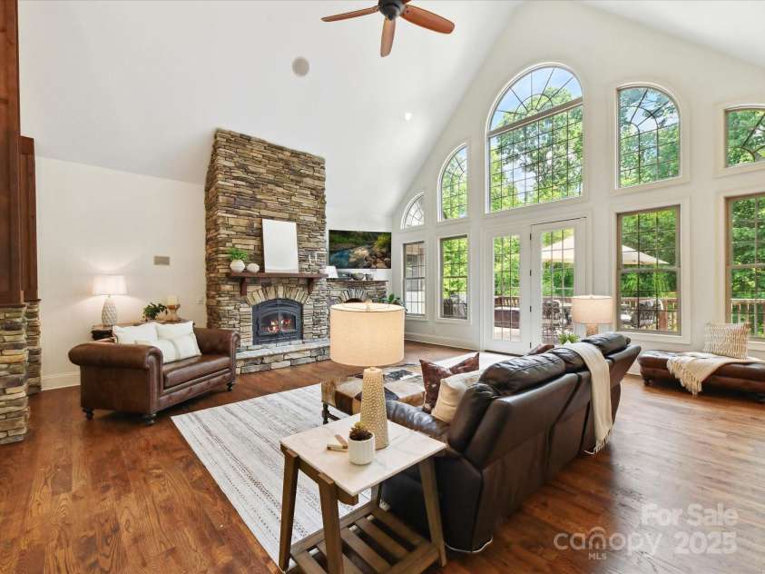 633 Elmhurst Drive, Fort Mill, SC 29715.  MLS# CAR4245784, YatesRealty ID 23352. Gorgeous Airy Family room bathed in sunlight features a stone fireplace and pillars,  LVP Wood Plank and Marble flooring