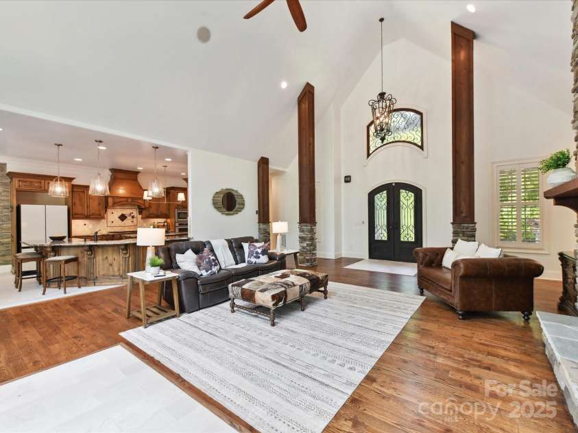 633 Elmhurst Drive, Fort Mill, SC 29715.  MLS# CAR4245784, YatesRealty ID 23352. Gorgeous Airy Family room bathed in sunlight features a stone fireplace and pillars,  LVP Wood Plank and Marble flooring