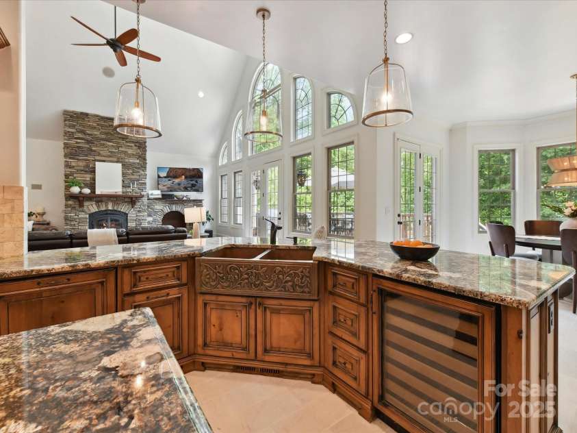 633 Elmhurst Drive, Fort Mill, SC 29715.  MLS# CAR4245784, YatesRealty ID 23352. The kitchen exudes elegance and functionality boasting a huge exotic granite breakfast bar and island, built in Wolf Stove, wall oven, 2 dishwashers, copper double farm sink & prep sink, pot filler, warming drawers, win