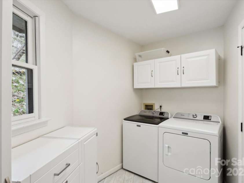 423 Grouse Thicket Road, Mars Hill, NC 28754.  MLS# CAR4220516, YatesRealty ID 23361. Laundry room off living room