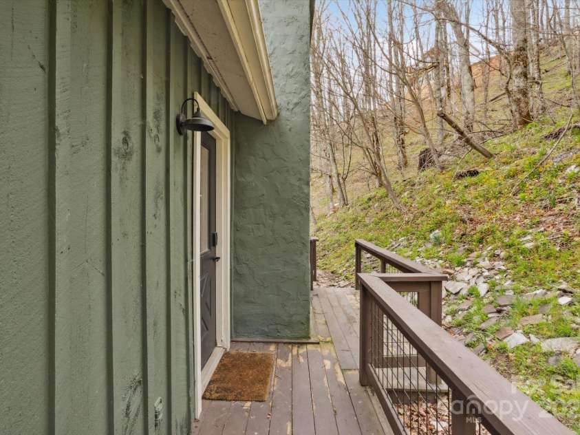 423 Grouse Thicket Road, Mars Hill, NC 28754.  MLS# CAR4220516, YatesRealty ID 23361. Wrap around deck - back side