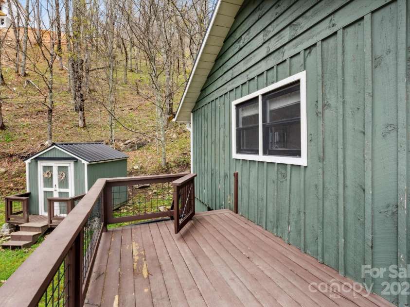 423 Grouse Thicket Road, Mars Hill, NC 28754.  MLS# CAR4220516, YatesRealty ID 23361. Wrap around deck - side with yard and storage shed
