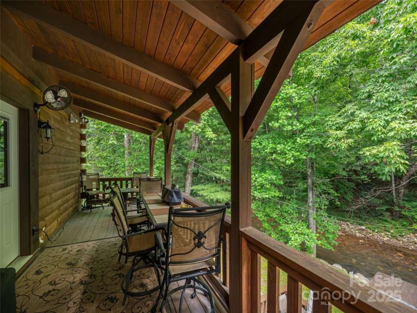 15 Breezy Creek Lane, Maggie Valley, NC 28751.  MLS# CAR4279649, YatesRealty ID 2337. Covered back deck overlooks creek