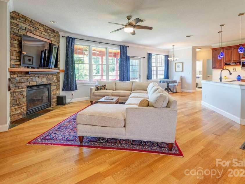 125 Ivy Meadows Drive, Weaverville, NC 28787.  MLS# CAR4247385, YatesRealty ID 23384. Open concept living room with gas fireplace