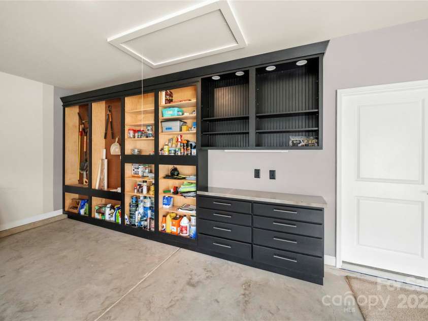 17028 River Race Drive, Huntersville, NC 28078.  MLS# CAR4259977, YatesRealty ID 23397. Custom-built cabinets and stainless steel workbench for the hobbyist