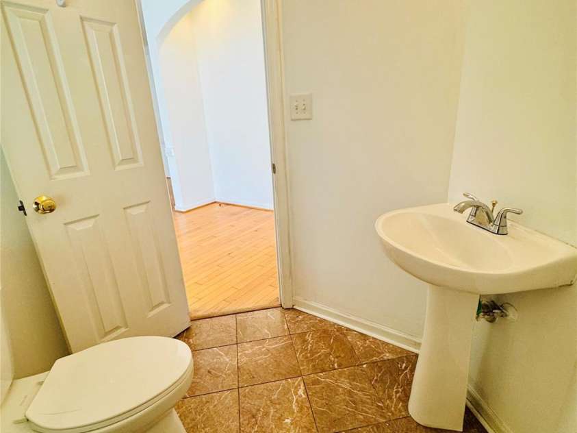 7411 Gate Key Court, Stanley, NC 28164.  MLS# CAR4335011, YatesRealty ID 2340. Guest Bathroom with view to the Foyer.