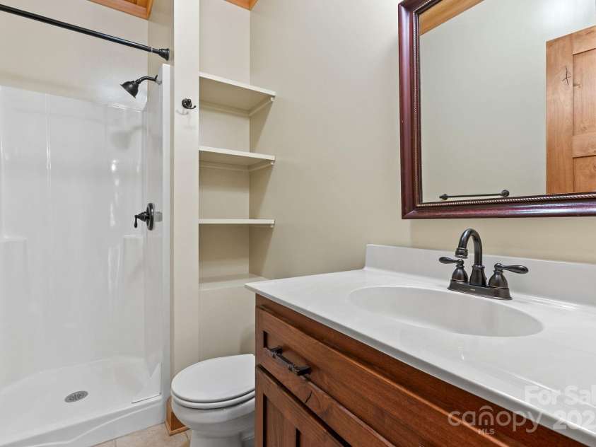 147 Brantley Branch Lane, Waynesville, NC 28786.  MLS# CAR4275100, YatesRealty ID 23400. Second full bathroom on main level