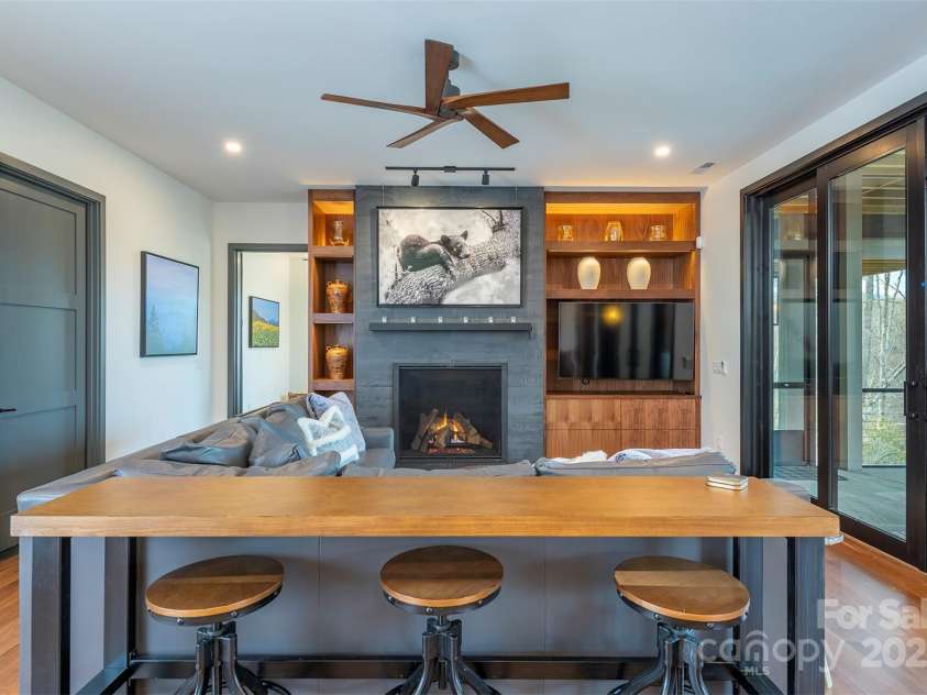 158 Riverbend Forest Drive, Asheville, NC 28805.  MLS# CAR4240684, YatesRealty ID 23402. Lower level sitting area with fireplace and extensive built-ins