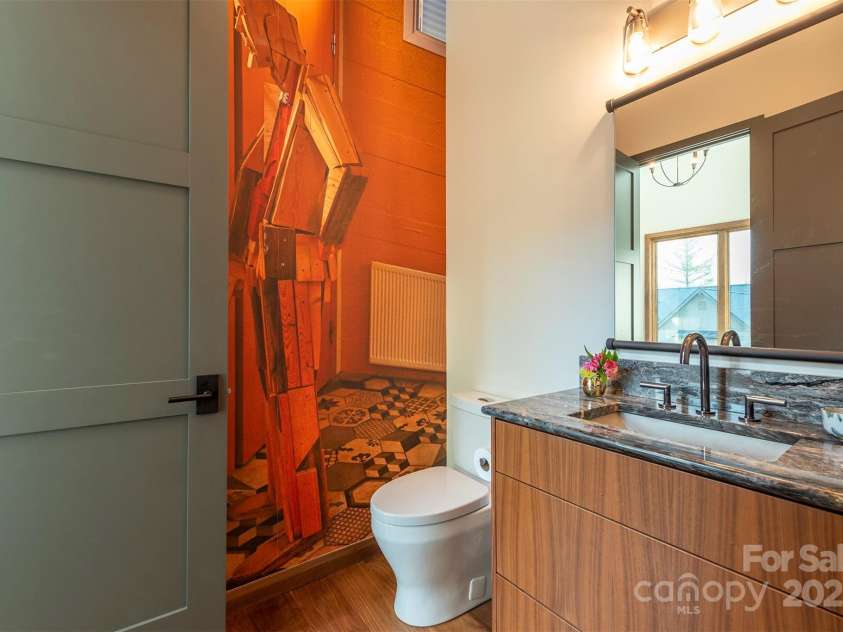 158 Riverbend Forest Drive, Asheville, NC 28805.  MLS# CAR4240684, YatesRealty ID 23402. Main floor powder room with removable mural