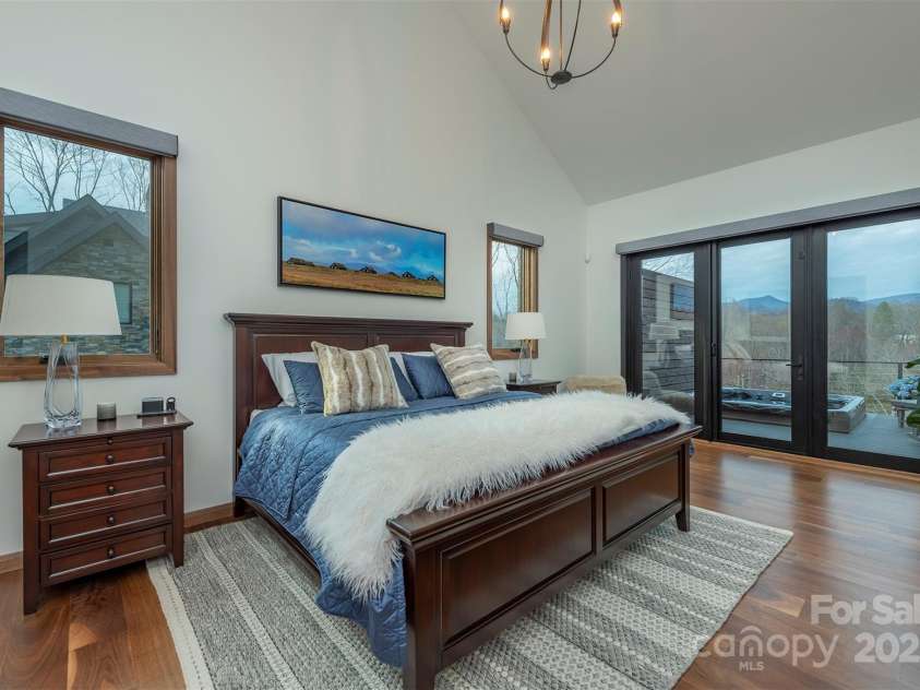 158 Riverbend Forest Drive, Asheville, NC 28805.  MLS# CAR4240684, YatesRealty ID 23402. Main level primary bedroom with access to deck and hot tub