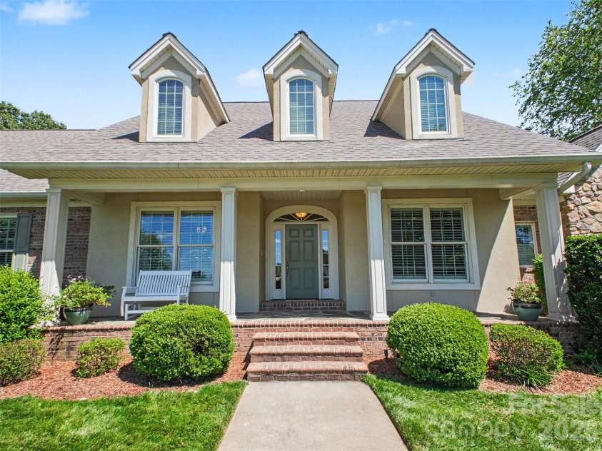 1422 Stone Gate Drive, Shelby, NC 28150.  MLS# CAR4358985, YatesRealty ID 23404. A large covered porch and pristine landscaping greet you. Sellers added landscape lighting for ambiance at night.