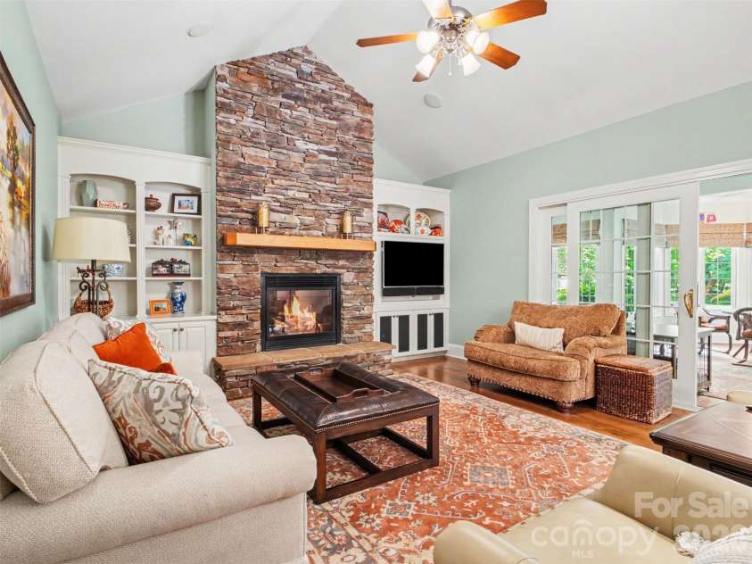 1422 Stone Gate Drive, Shelby, NC 28150.  MLS# CAR4358985, YatesRealty ID 23404. ...and stone gas fireplace focal point flanked by built-in shelves and cabinets. The television seen here conveys with the home. This fireplace has a remote and blower as well.