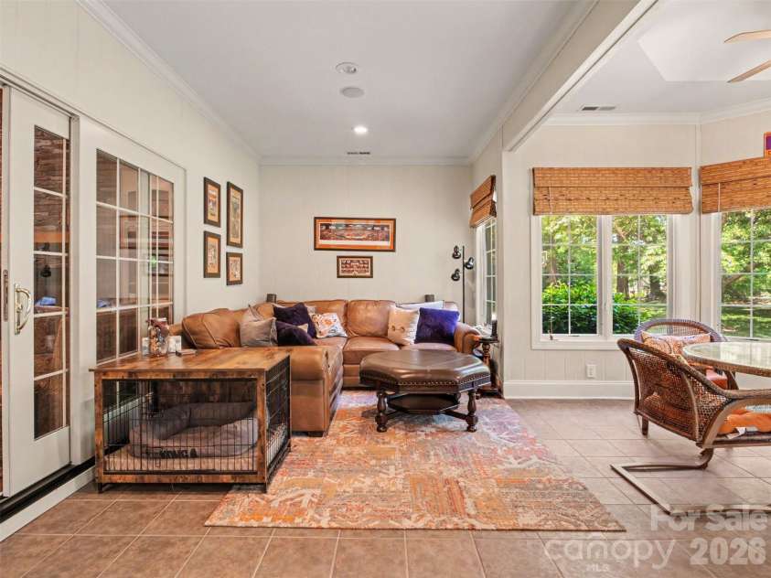 1422 Stone Gate Drive, Shelby, NC 28150.  MLS# CAR4358985, YatesRealty ID 23404. Sliding doors in the family room access the bright and airy sunroom...the perfect setting for morning coffee, reading, or casual gathering year-round.