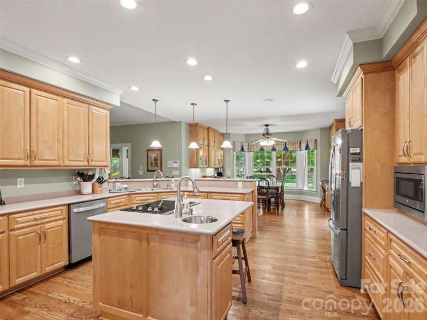 1422 Stone Gate Drive, Shelby, NC 28150.  MLS# CAR4358985, YatesRealty ID 23404. The open kitchen is in the middle of the home and features a center island with a built-in cooktop and prep sink,...
