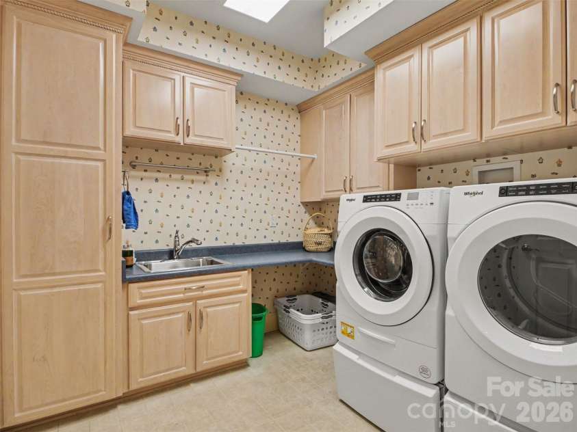 1422 Stone Gate Drive, Shelby, NC 28150.  MLS# CAR4358985, YatesRealty ID 23404. There is a conveniently located separate laundry room with a sink, folding/work space, hanging area, built-in ironing board, and plenty of storage! The washer and dryer convey.