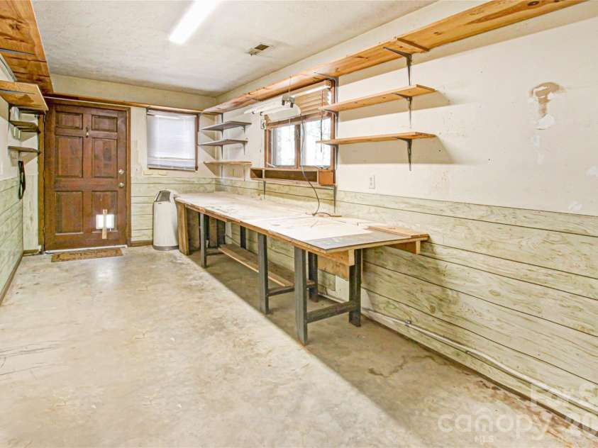 540 Chickadee Lane, Brevard, NC 28712.  MLS# CAR4363992, YatesRealty ID 23422. Basement Workshop/Mud Rm