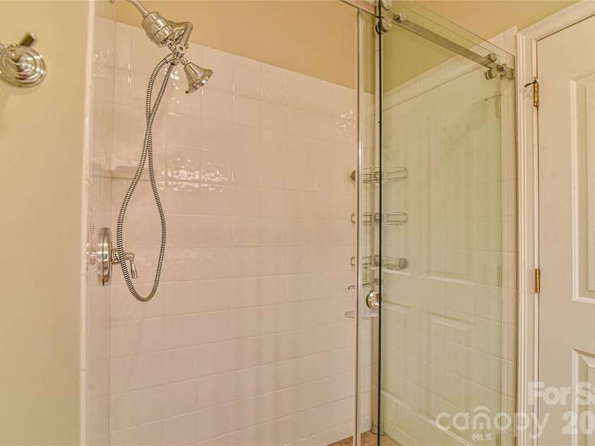 11 Outlook Circle, Swannanoa, NC 28778.  MLS# CAR4380390, YatesRealty ID 23426. Primary walk-in tiled shower with glass doors. 