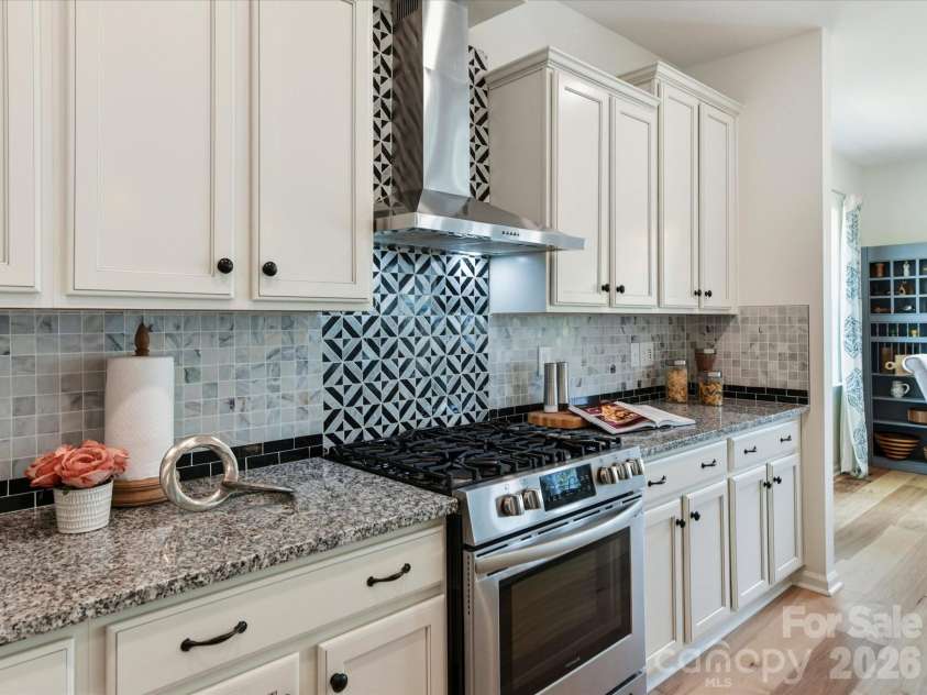 5116 Lassen Volcanic Trail, Lancaster, SC 29720.  MLS# CAR4377413, YatesRealty ID 23434. Vented Range Hood over Gas Range/Oven. Designer Backsplash and Tiled Accent Wall