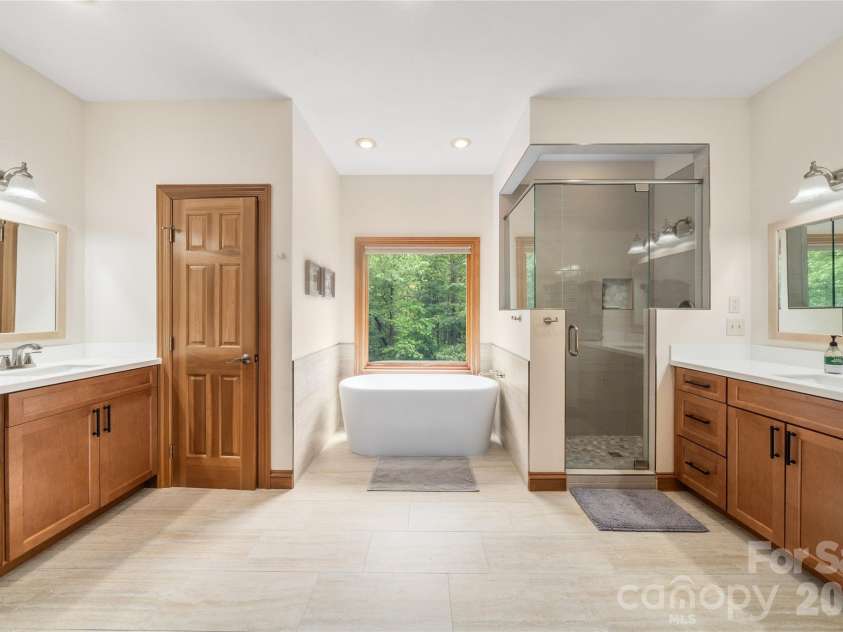 176 Hemlock Lane, Lake Lure, NC 28746.  MLS# CAR4374433, YatesRealty ID 23437. Primary bath with double sinks, tub and shower