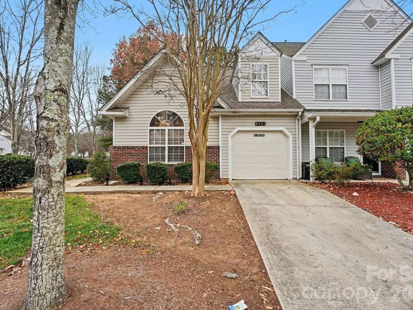 8331 Christmas Court, Charlotte, NC 28216.  MLS# CAR4340042, YatesRealty ID 2344. Front of townhome with a 1 car garage, and a two car parking driving area