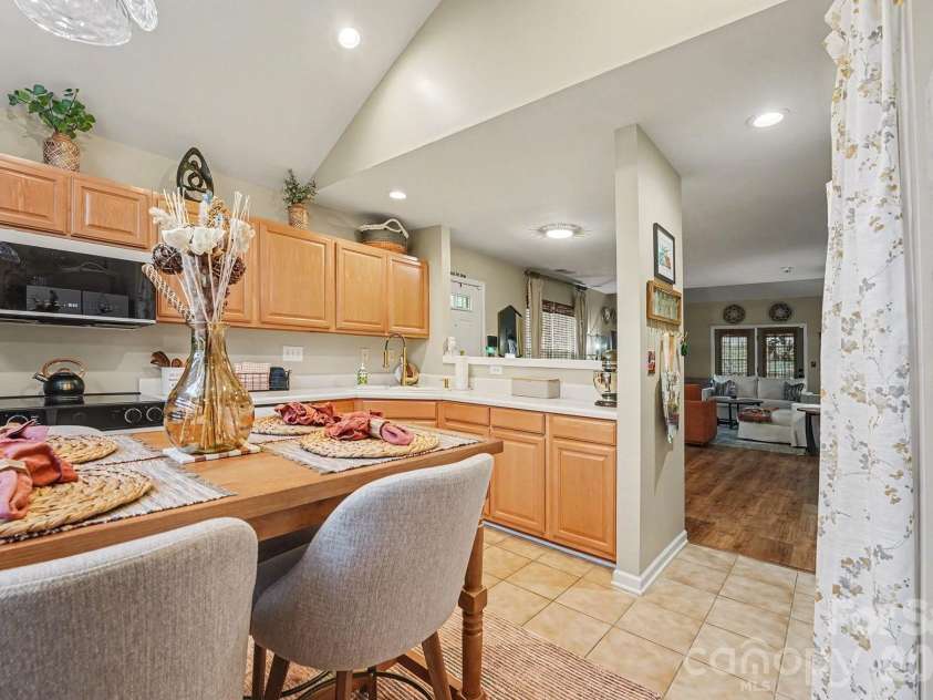 8331 Christmas Court, Charlotte, NC 28216.  MLS# CAR4340042, YatesRealty ID 2344. Kitchen with breakfast area, built-in cabinet pantry area, tile floors, newly updated appliances, and custom blinds.