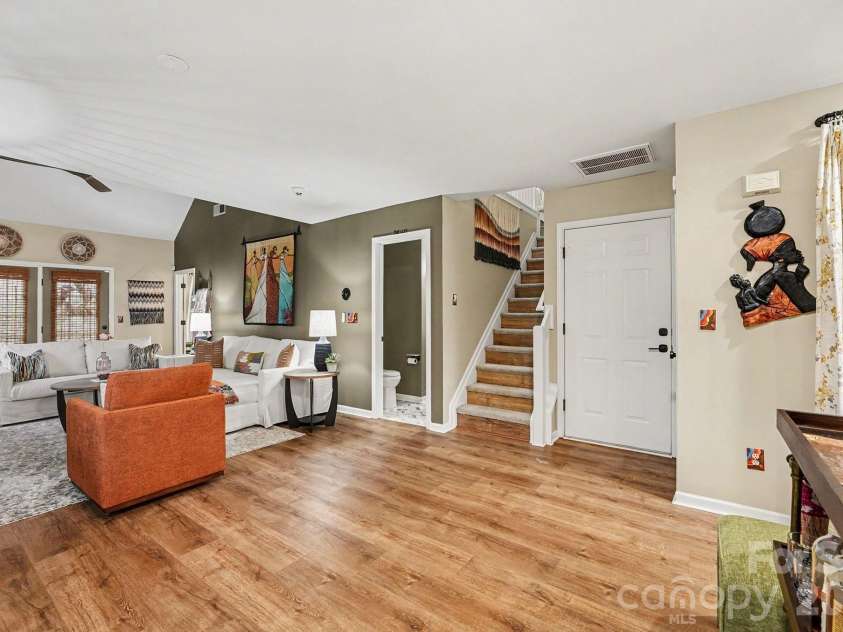 8331 Christmas Court, Charlotte, NC 28216.  MLS# CAR4340042, YatesRealty ID 2344. Living room with open floor plan, new LVP flooring, fresh paint, custom blinds, new fixtures, Eco Thermostat (Nest) and security system available.