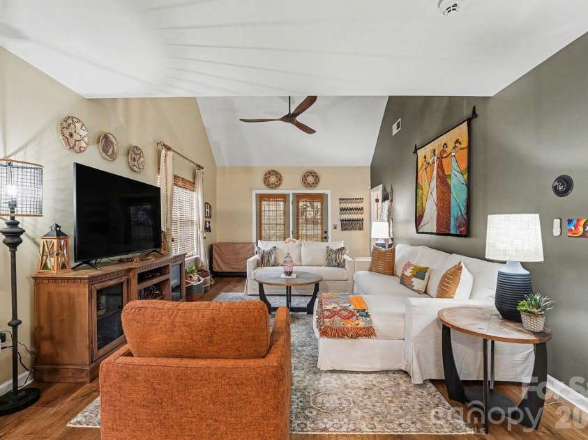 8331 Christmas Court, Charlotte, NC 28216.  MLS# CAR4340042, YatesRealty ID 2344. Living room with open floor plan, new LVP flooring, fresh paint, custom blinds, new fixtures, Eco Thermostat (Nest), security system available, and sealed gas fireplace available.