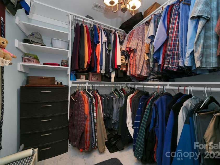 229 Hubbard Hollow Road, Rosman, NC 28772.  MLS# CAR4264936, YatesRealty ID 23454. Entering the large primary en-suite area the first door to the right is the walk-in closet.