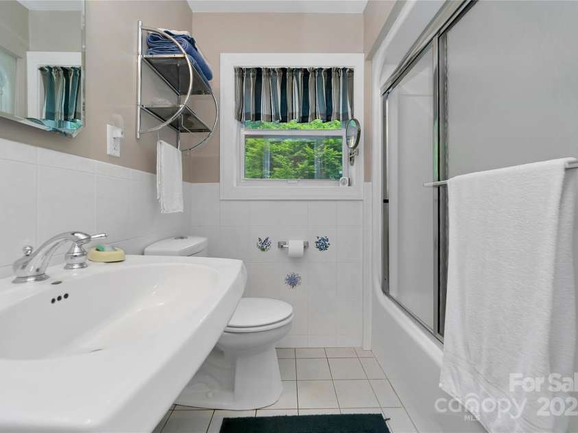 229 Hubbard Hollow Road, Rosman, NC 28772.  MLS# CAR4264936, YatesRealty ID 23454. The primary suite bathroom is white, light and bright.