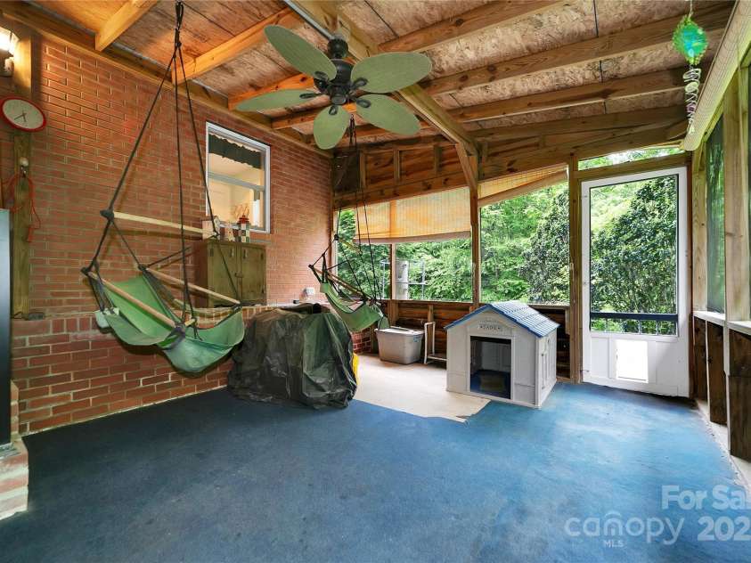 229 Hubbard Hollow Road, Rosman, NC 28772.  MLS# CAR4264936, YatesRealty ID 23454. The screen porch in the back is spacious and also leads out to the fenced side yard.