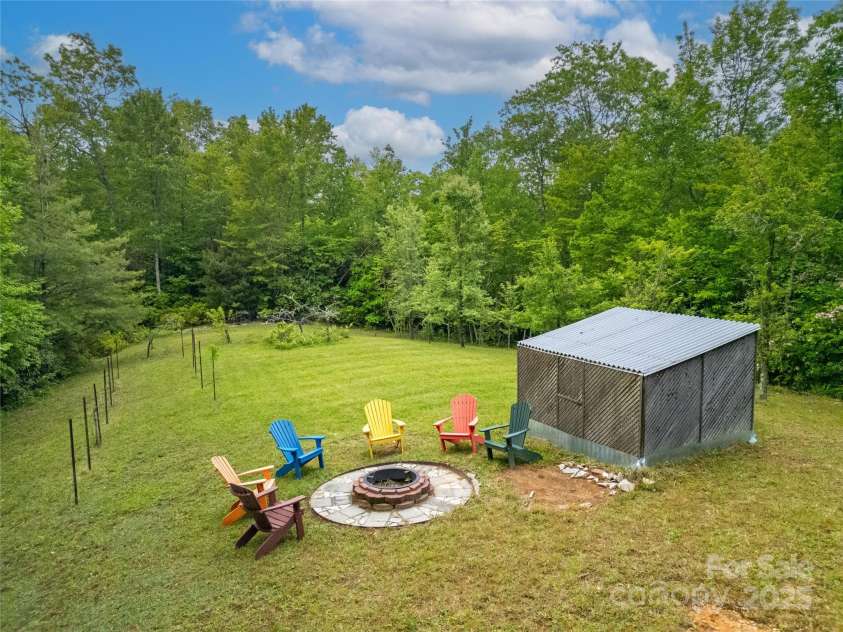 229 Hubbard Hollow Road, Rosman, NC 28772.  MLS# CAR4264936, YatesRealty ID 23454. This knoll is just across the spring run from the house. The fire pit is a wonderful spot to watch the Indian Camp Mountain stars at night. This is a large open meadow, pear trees at the end, an old vineyard on the le