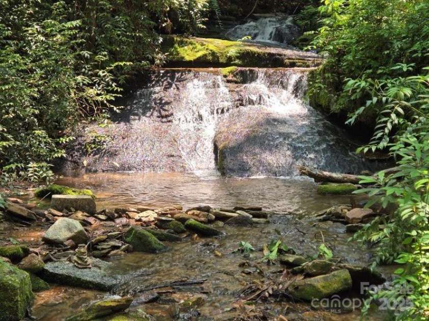 229 Hubbard Hollow Road, Rosman, NC 28772.  MLS# CAR4264936, YatesRealty ID 23454. This waterfall is at a neighbors house, called 