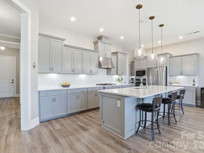 2015 Belle Mont Farm Avenue, Monroe, NC 28110.  MLS# CAR4369410, YatesRealty ID 23465. Chef’s kitchen featuring select cabinets with convenient pull-out shelving.