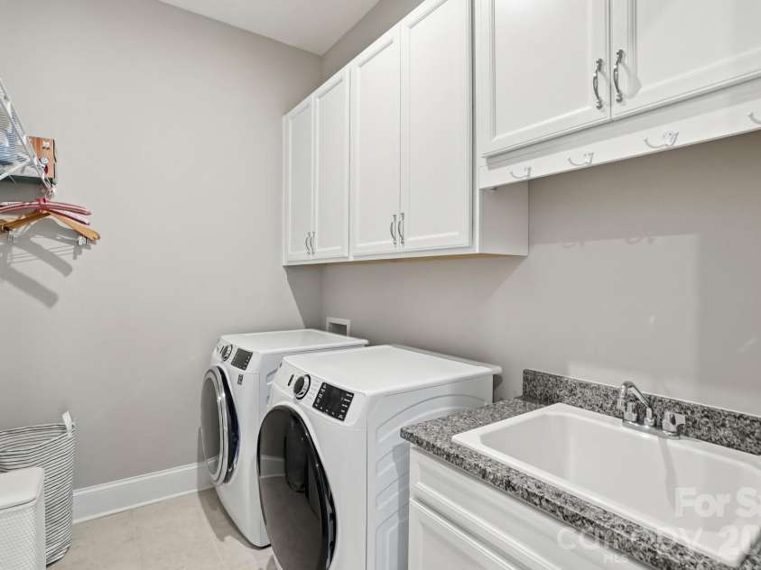 2015 Belle Mont Farm Avenue, Monroe, NC 28110.  MLS# CAR4369410, YatesRealty ID 23465. Nice size laundry with cabinets and sink