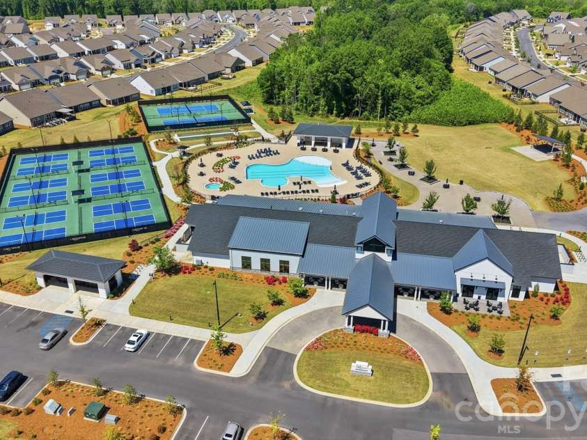 2015 Belle Mont Farm Avenue, Monroe, NC 28110.  MLS# CAR4369410, YatesRealty ID 23465. Outdoor pool, tennis and pickleball courts and a large outdoor pavilion for parties and concert events. Top right of photo