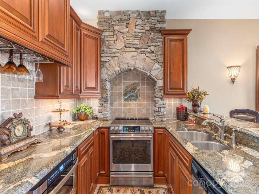 574 Leatherwood Drive, Maggie Valley, NC 28751.  MLS# CAR4275910, YatesRealty ID 23479. Lower level full kitchen includes stainless steel appliances and a breakfast bar