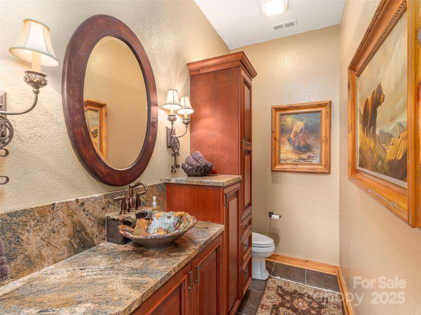 574 Leatherwood Drive, Maggie Valley, NC 28751.  MLS# CAR4275910, YatesRealty ID 23479. Lower level half-bath off den