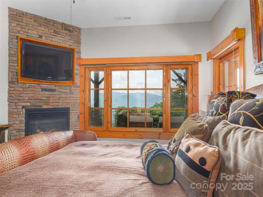 574 Leatherwood Drive, Maggie Valley, NC 28751.  MLS# CAR4275910, YatesRealty ID 23479. Lower primary features striking views and a gas fireplace, perfect for mtn evenings